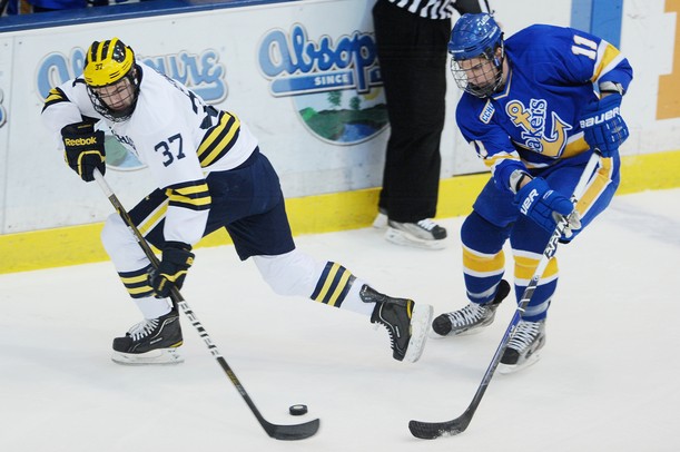 Michigan sophomore Mac Bennett looks to move the puck around Lake Superior State sophomore Colin Campbell in the first period at Yost Arena on Friday night. Melanie Maxwell I AnnArbor.com